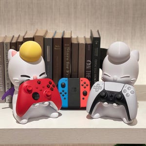 May include: A set of three ceramic mugs with a speckled, matte finish in cream, light grey, and dark grey. Each mug has a simple, minimalist design, suitable for coffee or tea.