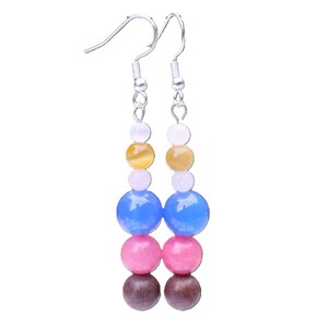 May include: A pair of dangle earrings with a silver hook and a series of colorful beads. The beads are arranged in a vertical line, featuring white, yellow, light pink, blue, pink, and brown beads. The earrings are designed for pierced ears.