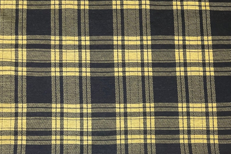 May include: Black and yellow plaid fabric with a woven texture.
