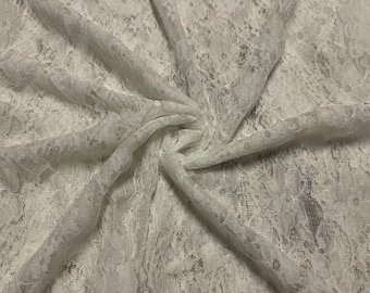 May include: White lace fabric with a delicate floral pattern. The fabric is soft and sheer, and it has a slightly textured surface.