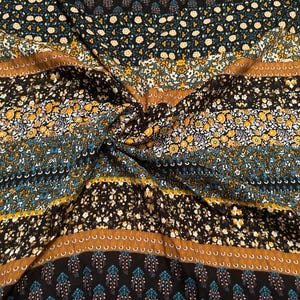 May include: A fabric featuring a repeating horizontal pattern of floral and geometric motifs in shades of black, mustard yellow, teal, and white. The textile displays distinct bands of intricate botanical designs and solid color stripes.