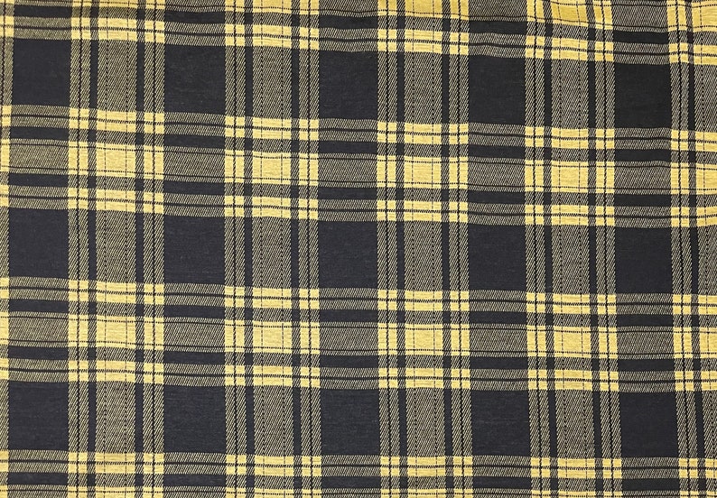 May include: Black and yellow plaid fabric with a woven texture.
