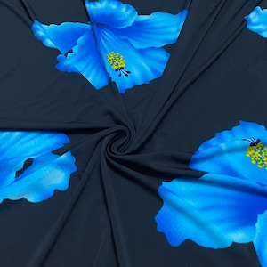 May include: Blue floral print fabric with a dark blue background. The fabric is soft and has a smooth texture.