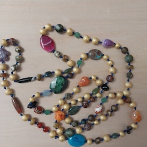 Soft fashion summer fun day necklace. 56" linear inches of gold plated 10mm beads interspersed with dozens of "candies," hand knotted silk.