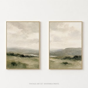 May include: A set of two vertical landscape art prints in gold frames, featuring muted green hills, rolling fields, and a cloudy sky. The text VINTAGE ART SET ©PAPERRIA PRINTS is printed in small black letters at the bottom centre of the image.