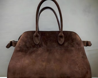 Fashionable suede tote handbag with a soft suede top handle, perfect for women seeking a stylish and versatile accessory