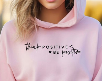 May include: Pink hooded sweatshirt with the text "Think Positive ♥ Be Positive" in black.