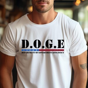 May include: White t-shirt with a black graphic that says "D.O.G.E. DEPARTMENT OF GOVERNMENT EFFICIENCY" with a red and blue stripe underneath.