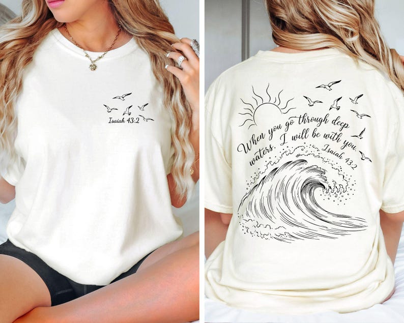 May include: Cream-colored t-shirt with a black graphic of seagulls and the text "Isaiah 43:2" on the front. The back features a sun, seagulls, a wave, and the quote "When you go through deep waters. I will be with you. Isaiah 43:2."