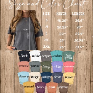 May include: A size and color chart for t-shirts. The chart displays various colors, including black, white, and seafoam. Measurements are provided in inches for width and length, ranging from size S to 2XL. The image shows a person wearing a gray t-shirt.