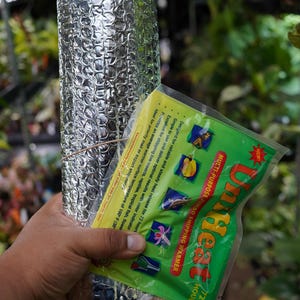 May include: A rolled silver bubble wrap insulation and a green and yellow multi-purpose jumbo shipping warmer. The warmer is designed for shipping live insects, reptiles, and tropical fish. The warmer provides a surface temperature of 100°F.