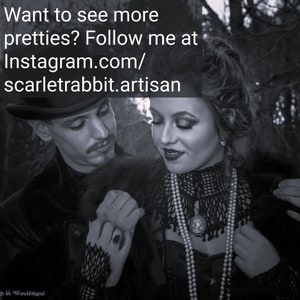 May include: A black and white photograph of a couple in a gothic style. The woman is wearing a black lace top with a pearl necklace and the man is wearing a black suit with a top hat. The text "Want to see more pretties? Follow me at instagram.com/scarletrabbit.artisan" is visible in the image.