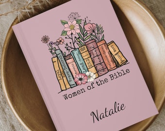May include: A pink journal with a floral design and the text "Women of the Bible" and "Natalie".