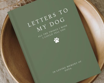 May include: A sage green journal with white text that reads LETTERS TO MY DOG, ALL THE THINGS I WISH I COULD TELL YOU, and IN LOVING MEMORY OF PIPPA, featuring a small white paw print icon centered on the front cover of the book.