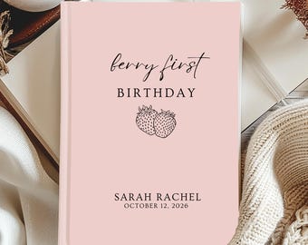 Puede incluir: Un diario rosa con el texto "berry first birthday" y una ilustración de fresas. El diario también incluye el nombre "SARAH RACHEL" y la fecha "OCTOBER 12, 2026". El diario está rodeado por una vela, un libro y elementos decorativos.