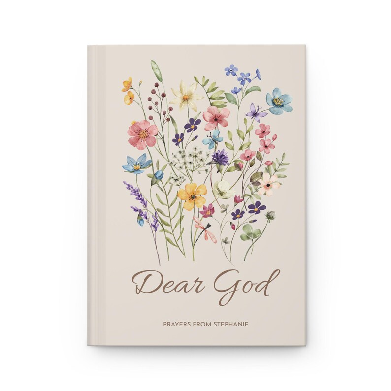 May include: A beige journal with a watercolour floral design. The cover features a bouquet of colourful flowers, including pink, blue, yellow, and purple blooms. The words "Dear God" are written in a script font, with "Prayers from Stephanie" below.