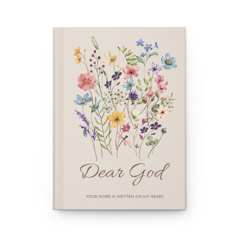 May include: A beige journal with a watercolour floral design. The cover features a bouquet of colourful flowers in shades of pink, yellow, blue, and purple. The words "Dear God" are written in a script font, with the phrase "Your word is written on my heart" below.