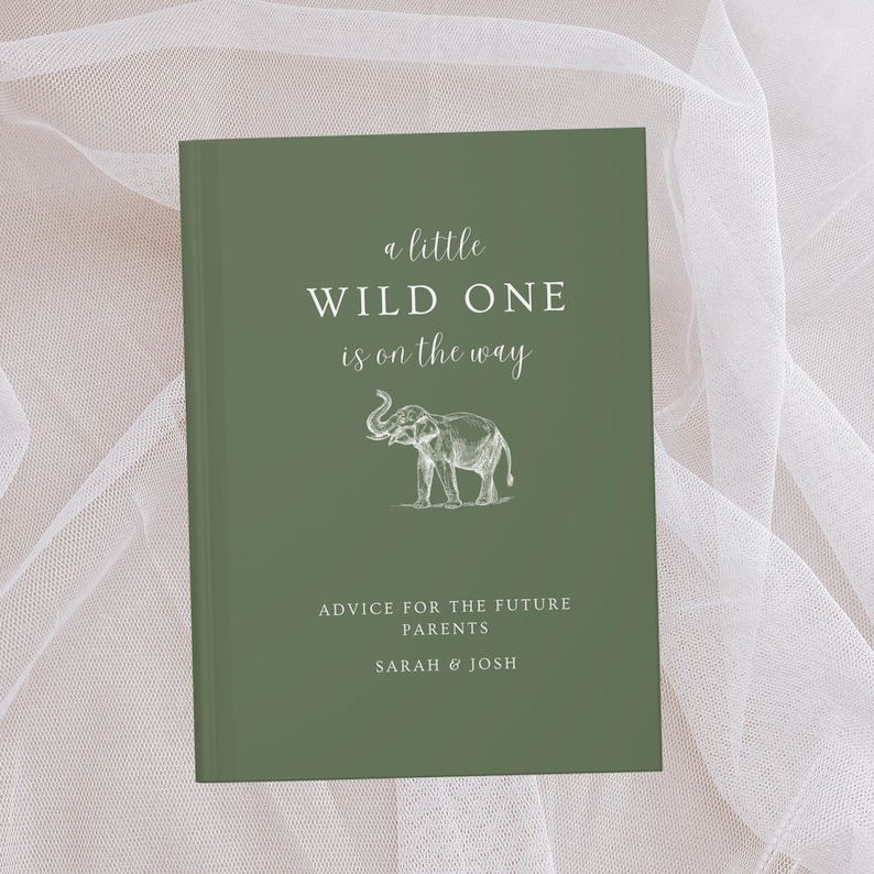 May include: A green book with the text "a little WILD ONE is on the way" in white cursive font. An illustration of an elephant is below the text. The text "ADVICE FOR THE FUTURE PARENTS SARAH & JOSH" is at the bottom of the book.