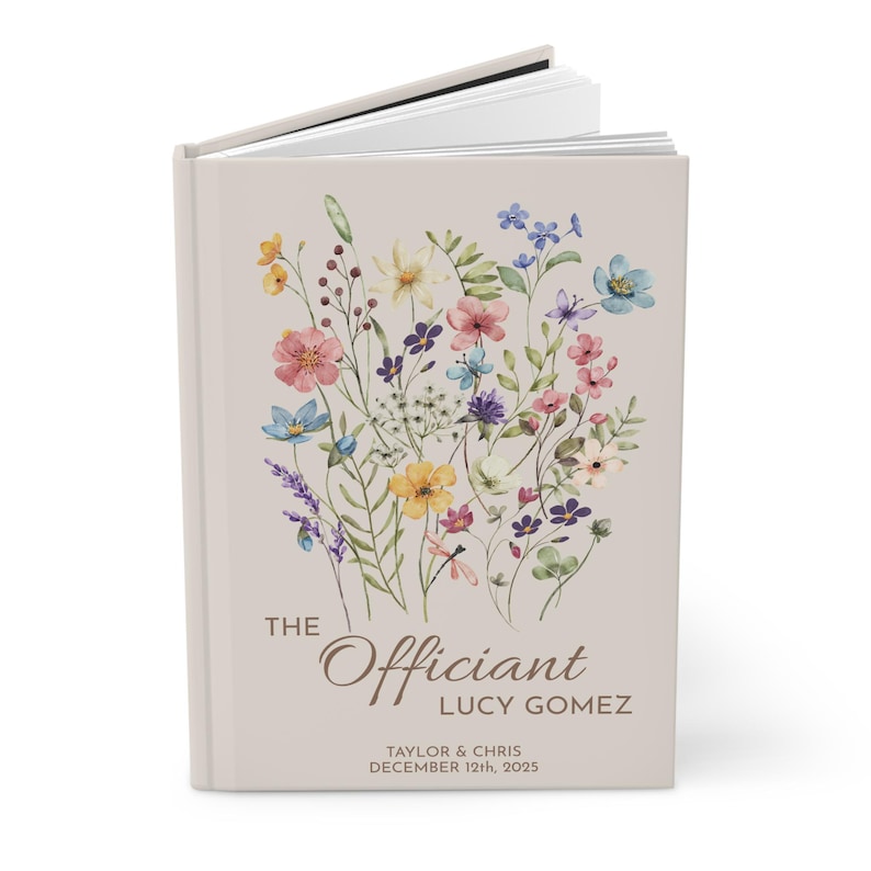 May include: A beige book cover with a floral design in shades of pink, yellow, blue, and green. The text "The Officiant Lucy Gomez" is printed in brown at the bottom of the cover, along with the date "December 12th, 2025".