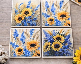 May include: Set of four square ceramic coasters with a sunflower and blue floral design. The coasters are water-resistant and have a protective cork backing. The text on the image says "Farmhouse 5x5 Sunflower & Blue Floral Coasters."