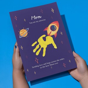 Cartão com a marca da mão da Mãe do Universo | Presente para imprimir da Rocket Space para o Dia das Mães | Citação "Você é o meu universo" | Lembrança DIY para uma mãe à distância