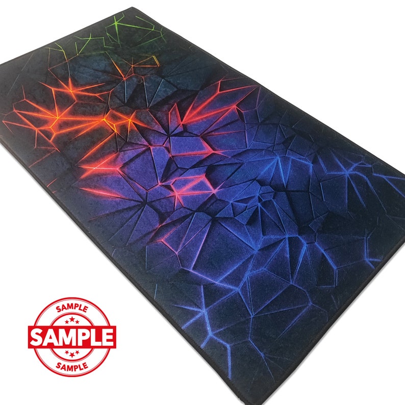 May include: A black mousepad with a geometric pattern in shades of blue, red, and green. The pattern resembles a cracked or broken surface with glowing lines.