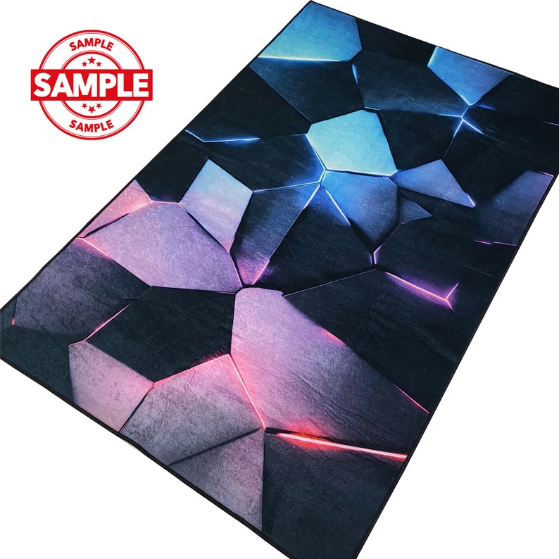 May include: Abstract geometric rug with a dark blue, purple, and pink color scheme. The rug features a pattern of large, irregular shapes with a textured, almost metallic appearance.