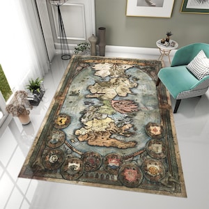 May include: A rectangular area rug featuring a vintage map design of the British Isles. The rug has a blue and tan color scheme with detailed illustrations of the landmasses, coastlines, and decorative crests around the border. The rug is placed on a white floor.