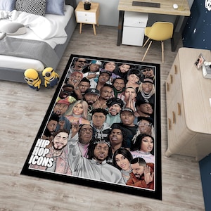 May include: A black and white rug with a collage of hip hop icons. The rug features a variety of artists, including rappers, singers, and producers. The rug is rectangular and has a black border. The text "Hip Hop Icons" is printed in white letters on the rug.