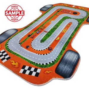 May include: Orange and gray race track rug shaped like a car. The rug has a finish line, checkered flags, and flames.