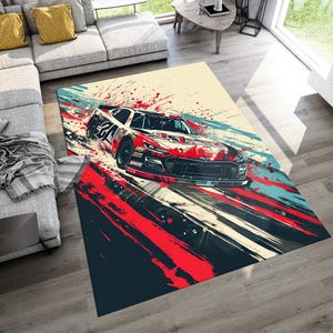 May include: A rectangular area rug featuring a dynamic, abstract illustration of a red and black race car in motion. The design incorporates bold splashes of red, teal, and cream, creating a sense of speed with streaking lines and paint splatters.