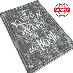 May include: A gray and white kitchen rug with the text "The Kitchen is the Heart of the Home" in a vintage style font.
