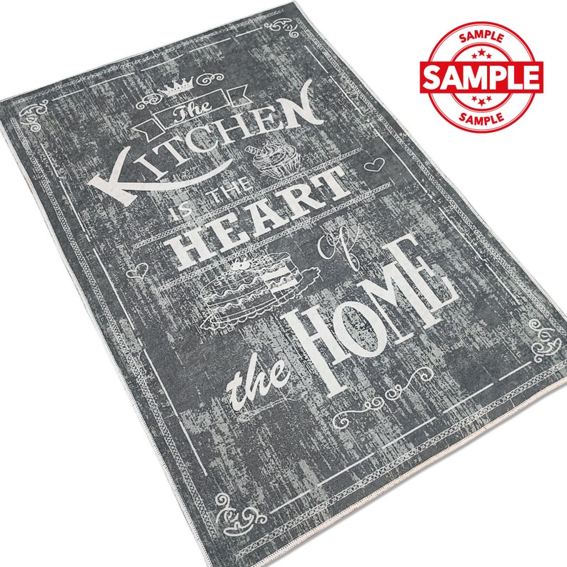 May include: A gray and white kitchen rug with the text "The Kitchen is the Heart of the Home" in a vintage style font.