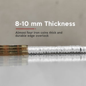 May include: Close-up of a white fabric with a thick, durable edge. The fabric is 8-10 mm thick, almost the thickness of four iron coins.