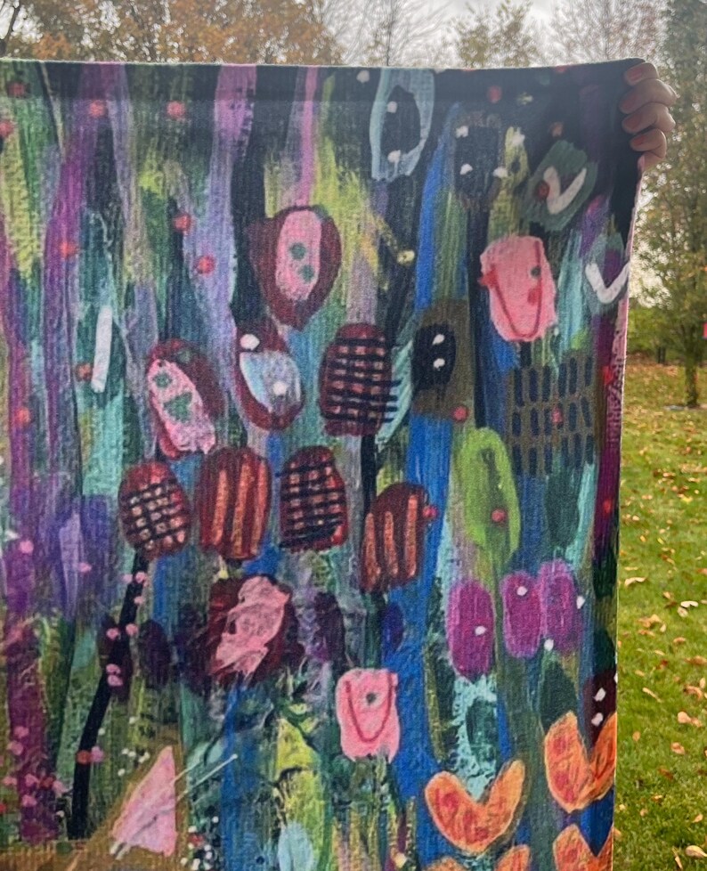 May include: Abstract art tapestry with a colorful, textured design featuring pink, blue, green, orange, and black. The tapestry has a vertical orientation and is made of fabric.