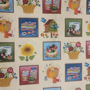 May include: A beige fabric featuring a repeating pattern of sewing-themed illustrations. The squares depict baskets of flowers, spools of thread, sewing machines, birdhouses, and stacks of fabric. The illustrations are framed in brown and feature a variety of colors.