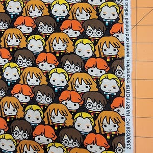 May include: A black fabric featuring a repeating pattern of cartoon Harry Potter characters with distinct hair colors and styles. The white selvage edge includes the text 23800228 MC HARRY POTTER characters, names and related indicia are & TM WBEI.