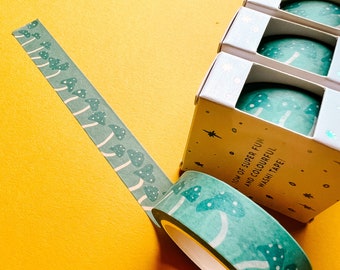 May include: Three rolls of washi tape with a mushroom design. The tape is teal blue with white mushrooms and white dots. The text on the packaging reads "Tons of Super Fun and Colourful Washi Tape!"