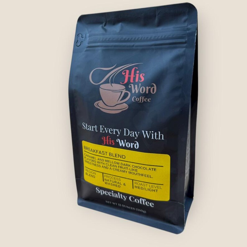 His Word Coffee Breakfast Blend 12 oz bag photographed at a three-quarter angle against a neutral off-white background, showing the full front label including the His Word Coffee logo, Start Every Day With His Word, the yellow Breakfast Blend label with tasting notes, and Specialty Coffee designation