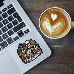 May include: A sticker featuring a skeleton with flowers and the text "NEVER BETTER".