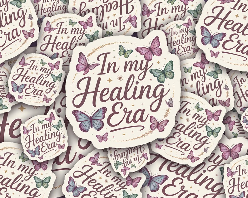 May include: A collection of stickers with a cream background, featuring the phrase "In my Healing Era" in a script font. The stickers are adorned with butterflies in shades of purple, blue, and green, creating a whimsical design.
