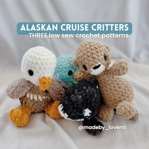 May include: A collection of handmade crochet Alaskan Cruise Critters. The group includes a white and brown duck, a teal sea creature, a brown bear, and a black and white orca. The text "ALASKAN CRUISE CRITTERS" and "THREE low sew crochet patterns" is displayed.