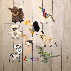May include: A collection of handmade crochet animal figures, including a yak, unicorn, sheep, ostrich, bull, zebra, vulture, and a dinosaur. The figures are in various colors and are displayed on a wooden background. The word "Home Artist" is visible.