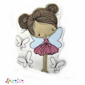 May include: Embroidered felt patch of a girl with brown hair and blue wings, wearing a pink dress and standing with butterflies around her.