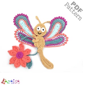 May include: Crochet pattern for a butterfly with a flower. The butterfly is tan with a smiling face and pink, blue, and green wings. The flower is coral with a pink center.