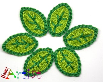 May include: Six crocheted green leaves with a lime green center. The leaves have a dark green border.