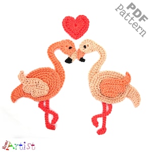 May include: Two crocheted pink flamingos with red hearts on their beaks, kissing. The flamingos are made with a light pink and peach yarn. The heart is made with a red yarn. The image is labeled "PDF pattern".