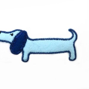May include: A light blue felt dachshund applique with dark blue felt ears and a black nose.