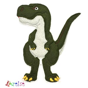 May include: A green and grey felt Tyrannosaurus Rex dinosaur with yellow claws and a red mouth. The dinosaur has a white belly and is standing upright. The image includes the text "Home Artist".