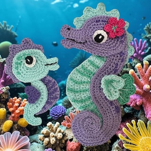 May include: Two crocheted seahorses, one larger and purple with a pink flower accent, and one smaller and light green with purple accents. Both feature white and black eyes, scalloped dorsal fins, and curled tails, crafted from yarn.